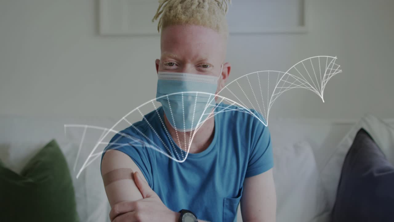 Mann som trekker i ermet og berører overarmen, partikler som danner DNA-spiral som viser helsevaksinested