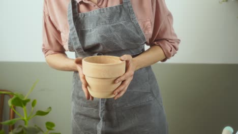 crop woman preparing pot for plants