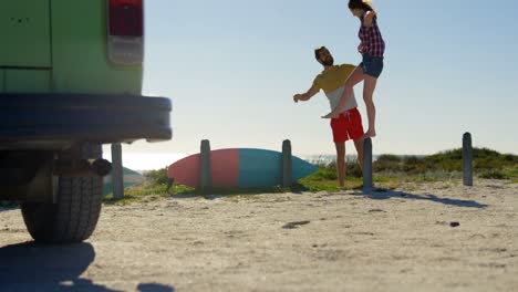 Young-woman-standing-on-concrete-post-at-beach-4k