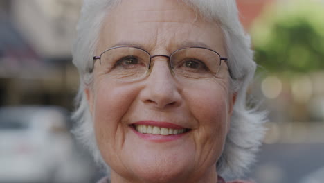 Portrait-of-happy-old-ladt-mature-woman-smiling-outdoors-in-city