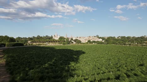 grey car drive on serene countryside road by chateau de pouzilhac castle, france, aerial