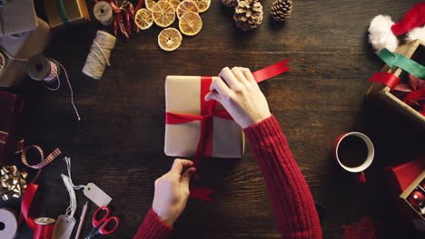 person wrapping christmas gift