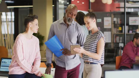 happy diverse business people discussing work during meeting at office