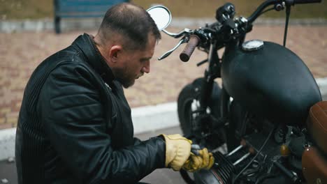 man repairing a custom motorcycle