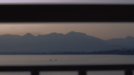 Evening-scene-with-sea-mountains-and-coastal-city