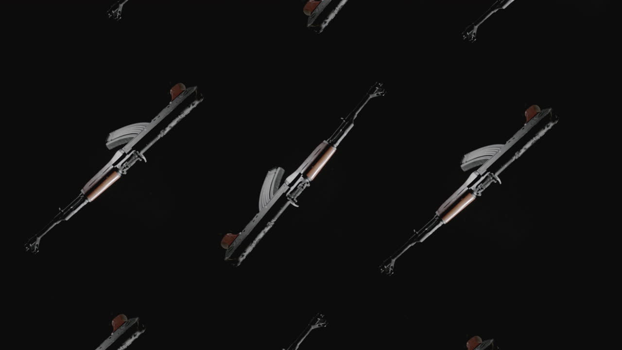 Machineguns on the dark background rotate in slowmotion