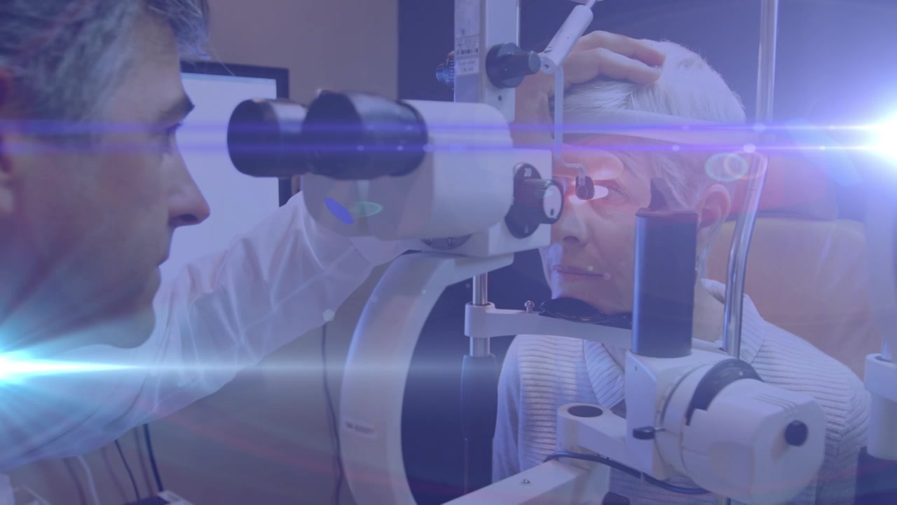 Animation of light trails over diverse doctor and patient using slit lamp