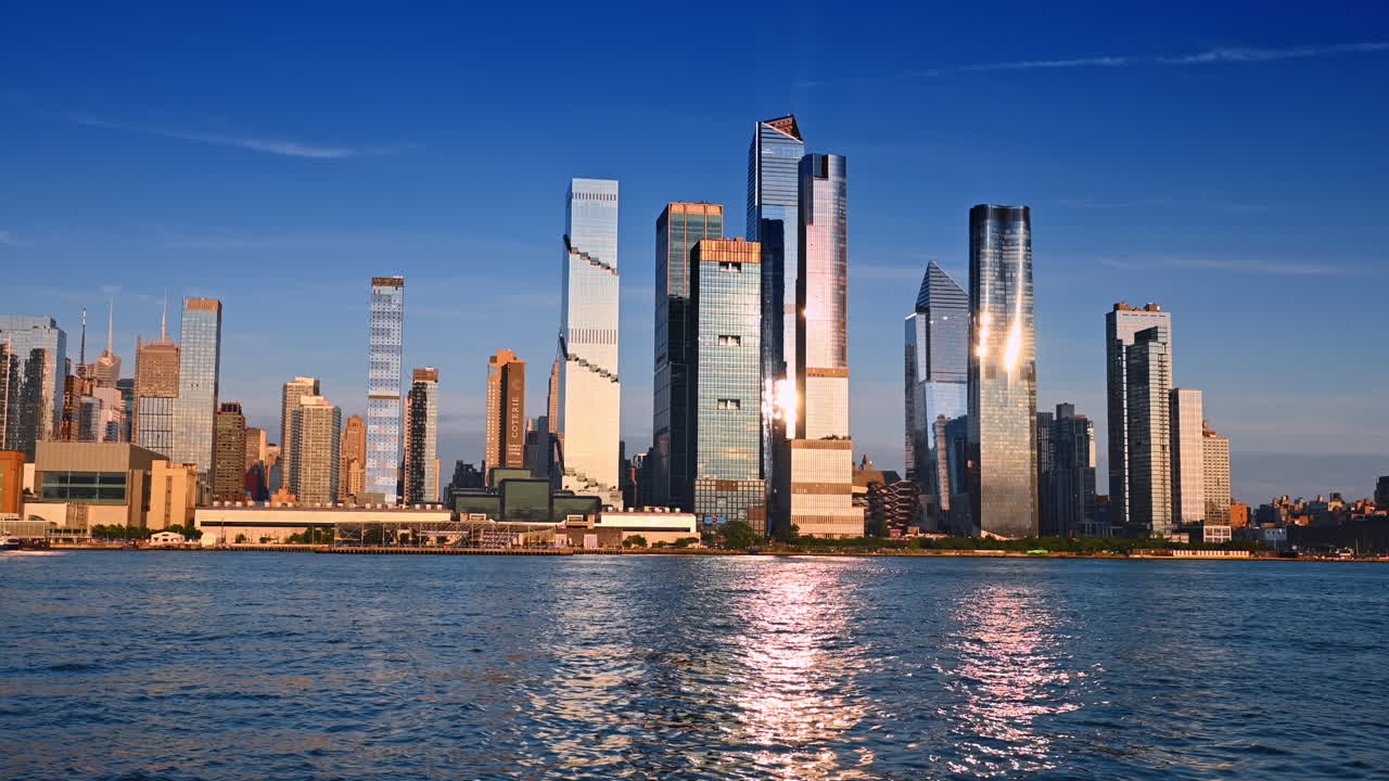 New York, USA, 15 April 2026: Wide Hudson Yards skyline over river water. Wide angle view of Hudson Yards skyline over Hudson River with reflections and clear blue sky