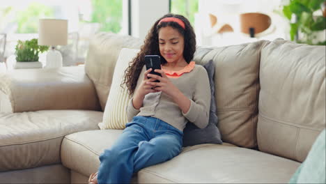 Phone,-search-and-girl-child-on-a-sofa-with-social