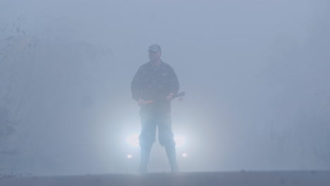 A-Murderer-With-A-Bloody-Ax-On-A-Forest-Road-Stands-In-The-Light-Of-Car-Headlights-Creepy-Crime-Scen