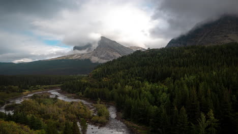 Lapso-De-Tiempo,-Nubes-Dramáticas-Sobre-Majestuoso-Paisaje-De-Montañas-Vírgenes,-Bosque,-Río-Glacial-Y-Picos