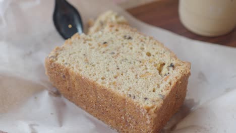 close-up of a person eating a slice of delicious carrot cake with coffee