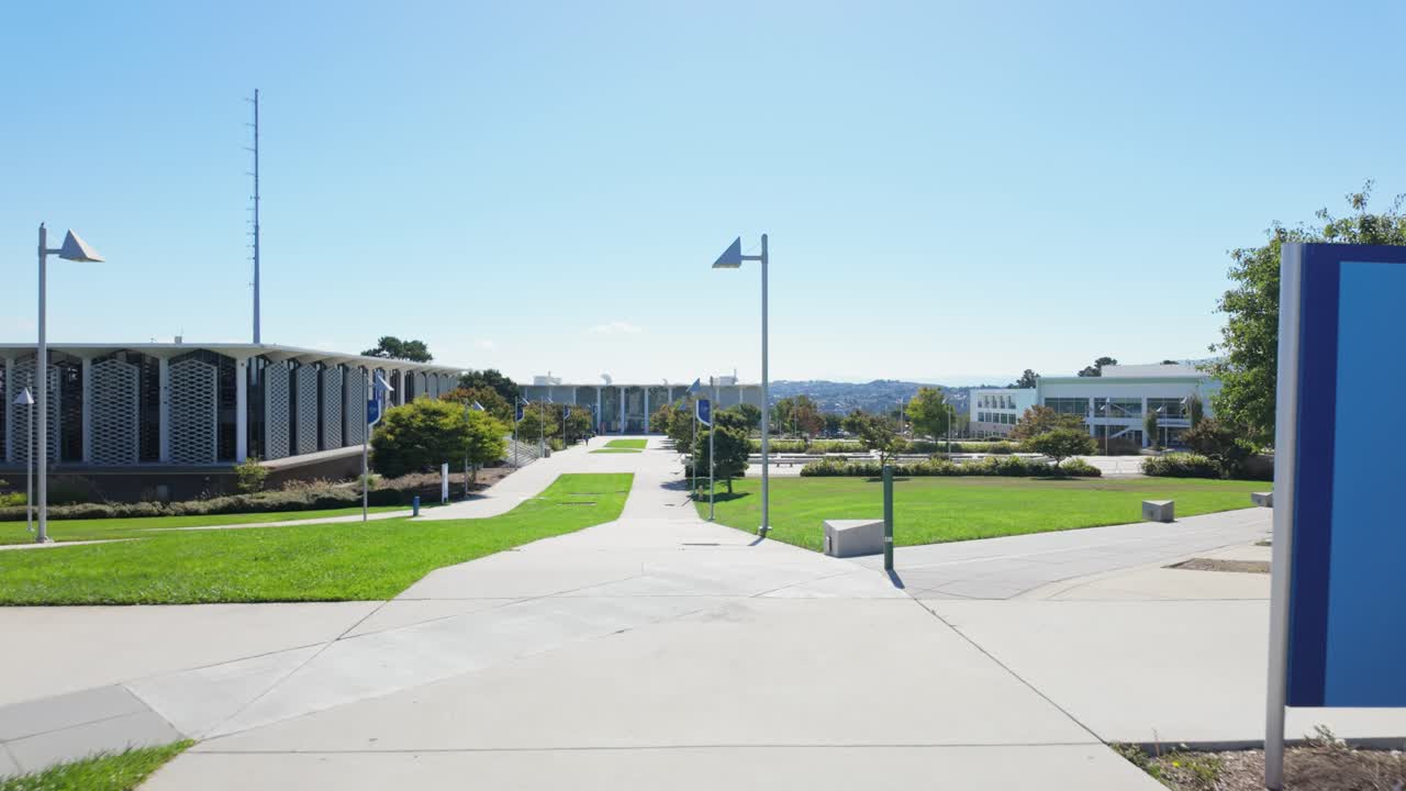 First-person angle captures the walkways at College of San Mateo with courtyards, benches, and landscaped features creating a welcoming campus atmosphere