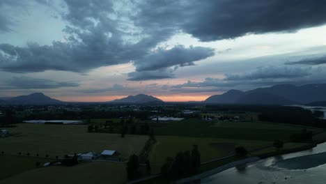 Farmland-and-River-surrounded-by-Mountains