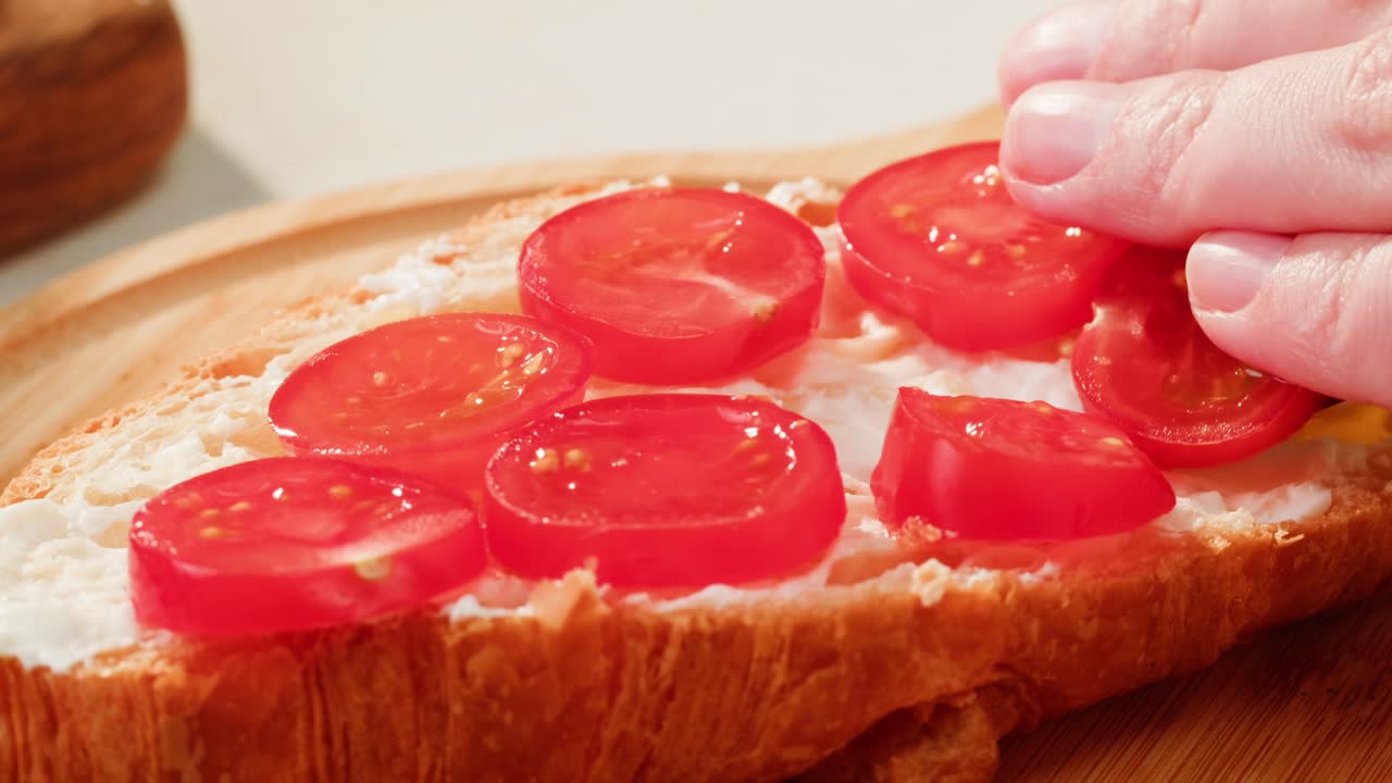 Preparing a Tomato and Cheese Croissant Sandwich