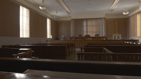 empty courtroom interior with benches and judge's stand