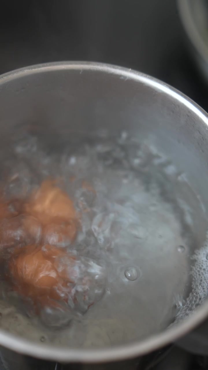 Brown Eggs Boiling in a Pot of Water