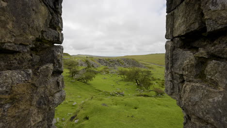 view through stone walls to a green valley