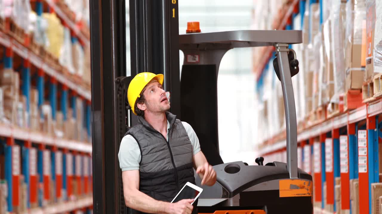 Male warehouse worker using digital tablet
