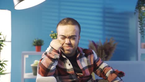 depressed young man with dwarfism crying at home alone. disabled young man suffers.