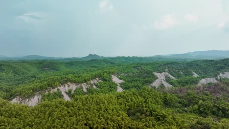 drone show showing green landscape covering moon world during cloudy day in taiwan, tianliao moon world, 田寮月世??