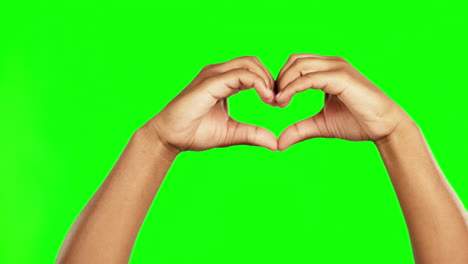 Hands,-green-screen-and-heart-shape-in-studio