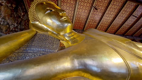 wat pho reclining golden buddha or wat phra chetuphon wimon mangkhalaram rajwaramahawihan buddha statue at the historic city center in bangkok, thailand