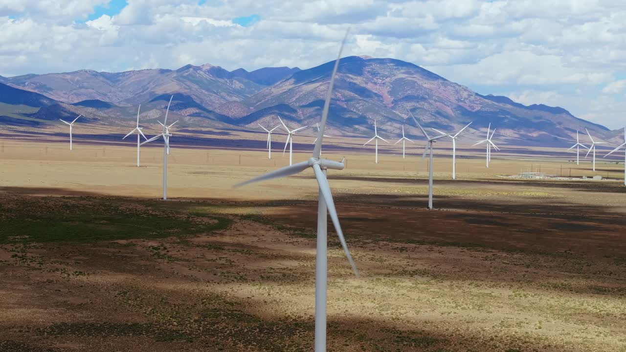 Wind turbines in Nevada desert with mountains, sustainable energy