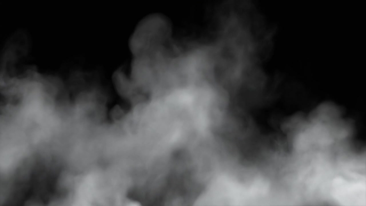 Humo blanco elevándose contra un fondo negro