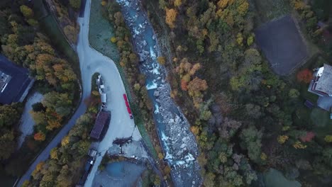 relaxed top down aerial flying over river in courmayeur, aosta valley, italy, alps