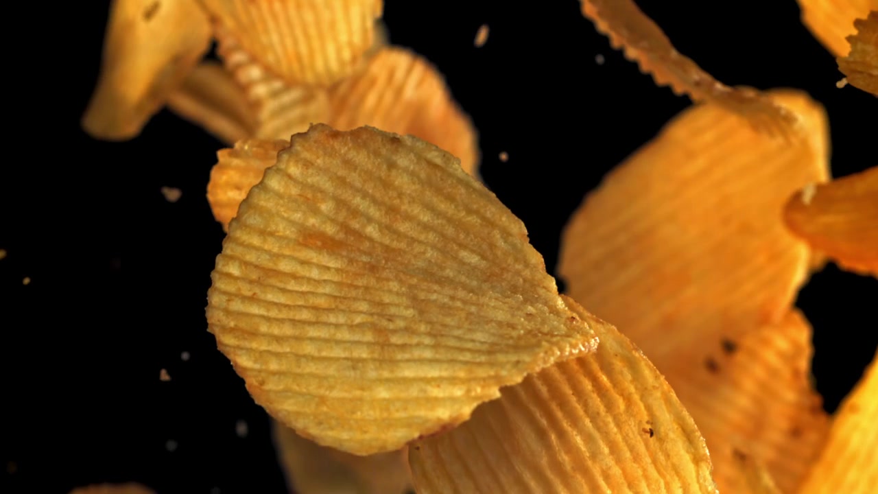 Crispy Golden Potato Chips Falling in Slow Motion
