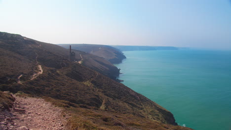 distant view of wheal coates tin mine at north cornwall coast near chapel porth beach in united kingdom