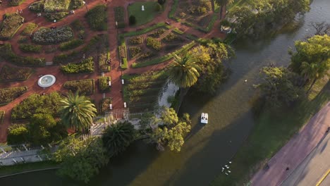 couple on pedal boats at sunset in palermo lakes, tres de febrero park at buenos aires city in argentina