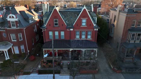 Slow-aerial-tilt-down-on-house-in-city-during-winter