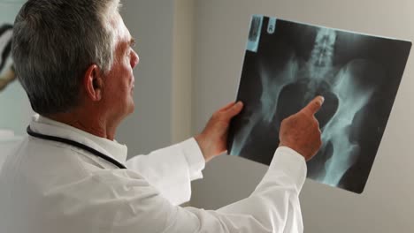 male doctor examining an x-ray