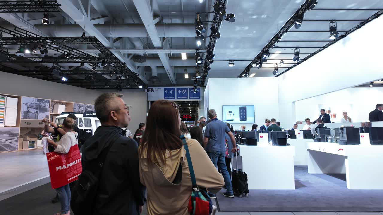 Walkthrough IFA exhibition in 2024, people wondering looking at tech products