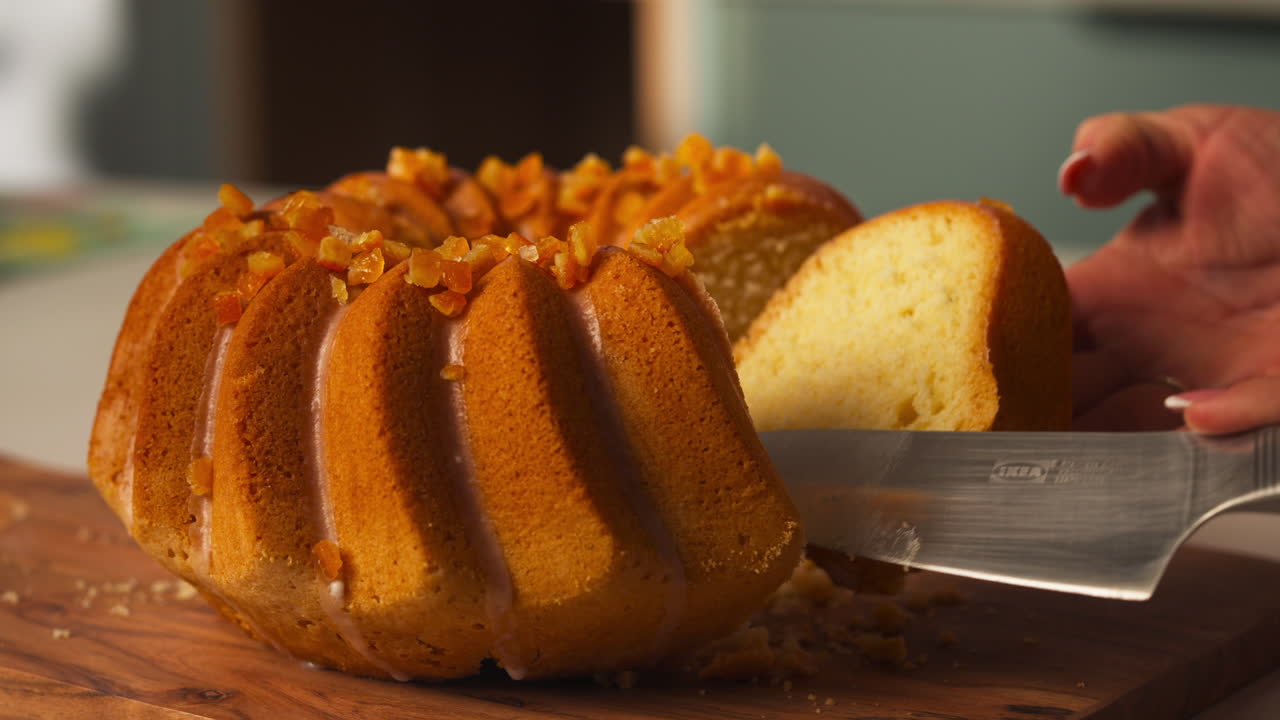 Knife cutting into glazed Easter bundt cake revealing soft interior