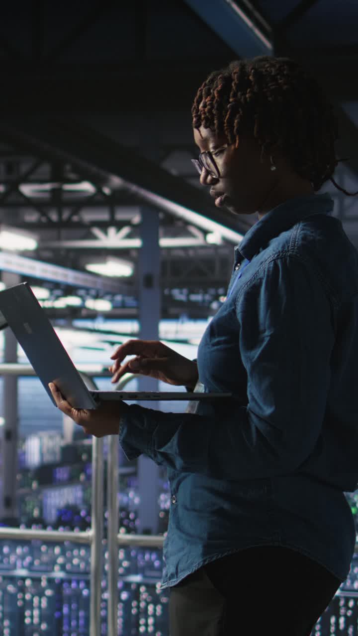 Vertical video Data center teamworking colleagues running diagnostics on equipment