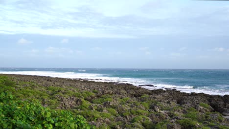 Rocky-seashore-under-cloudy-sky