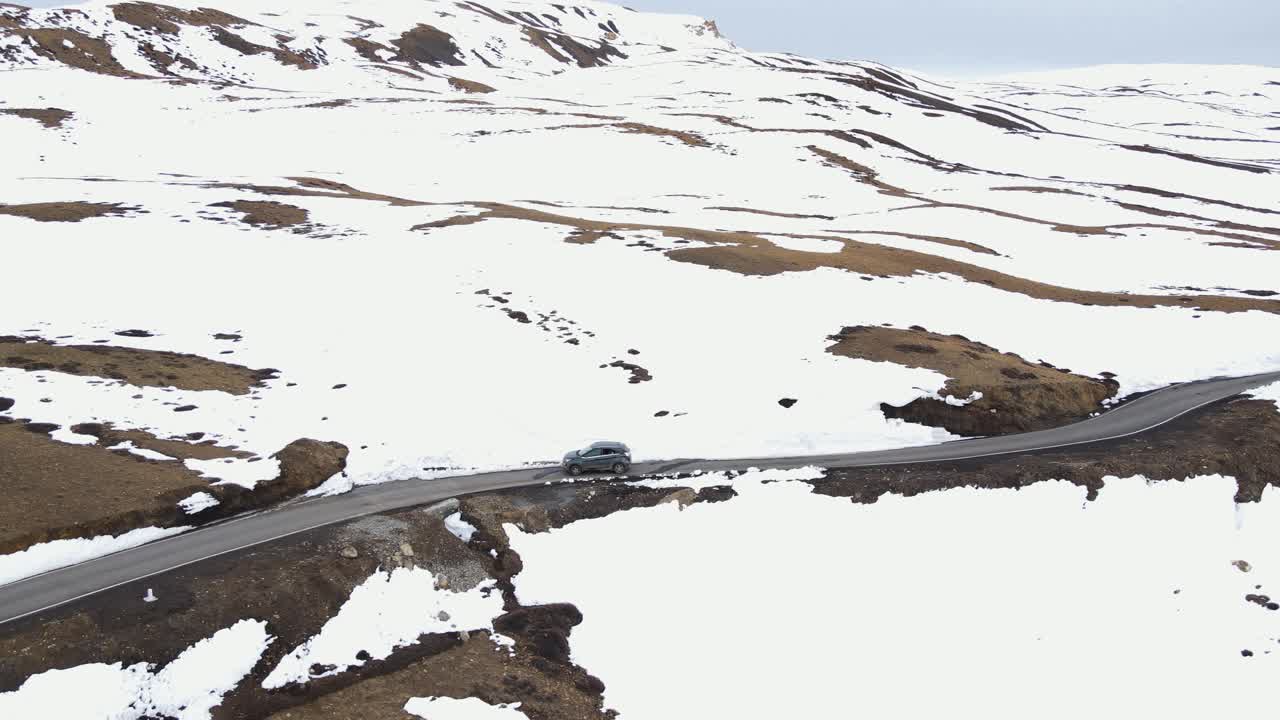 aerial snowy landscape of jeep driving on Komic a small village located in Spiti Tehsil of Lahaul and Spiti district of Himachal Pradesh World's Highest Village india