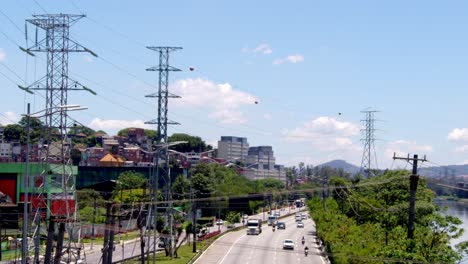 busy highway scene in a brazilian city with power lines and residential areas