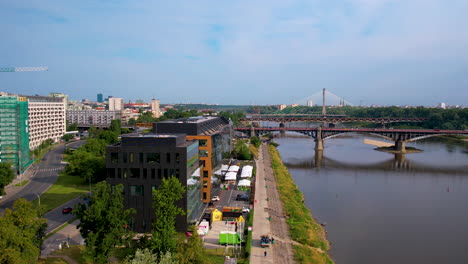 Aerial-view-over-Vistula-river-bank-of-Poniatowski-Bridge-in-Warsaw,-Poland