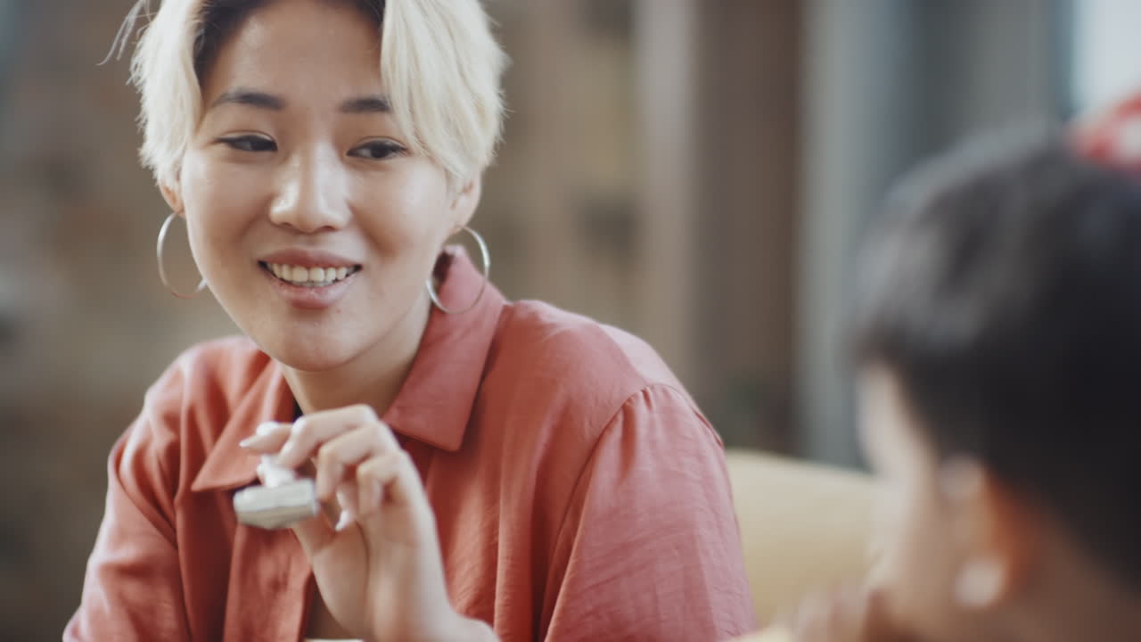 Asian Mother and Son Playing with Party Horns