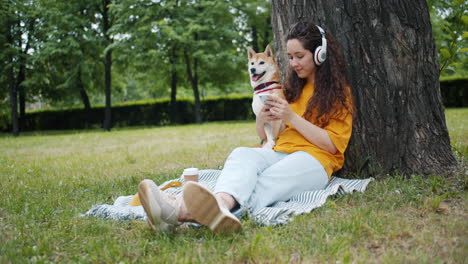 woman and dog relaxing in park