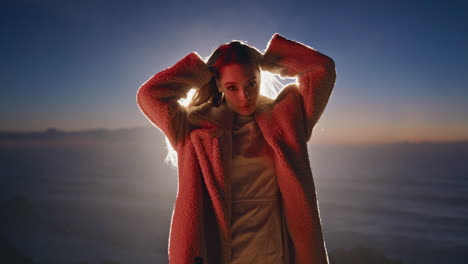 party woman dancing sunset beach closeup. neon girl moving hands posing at night