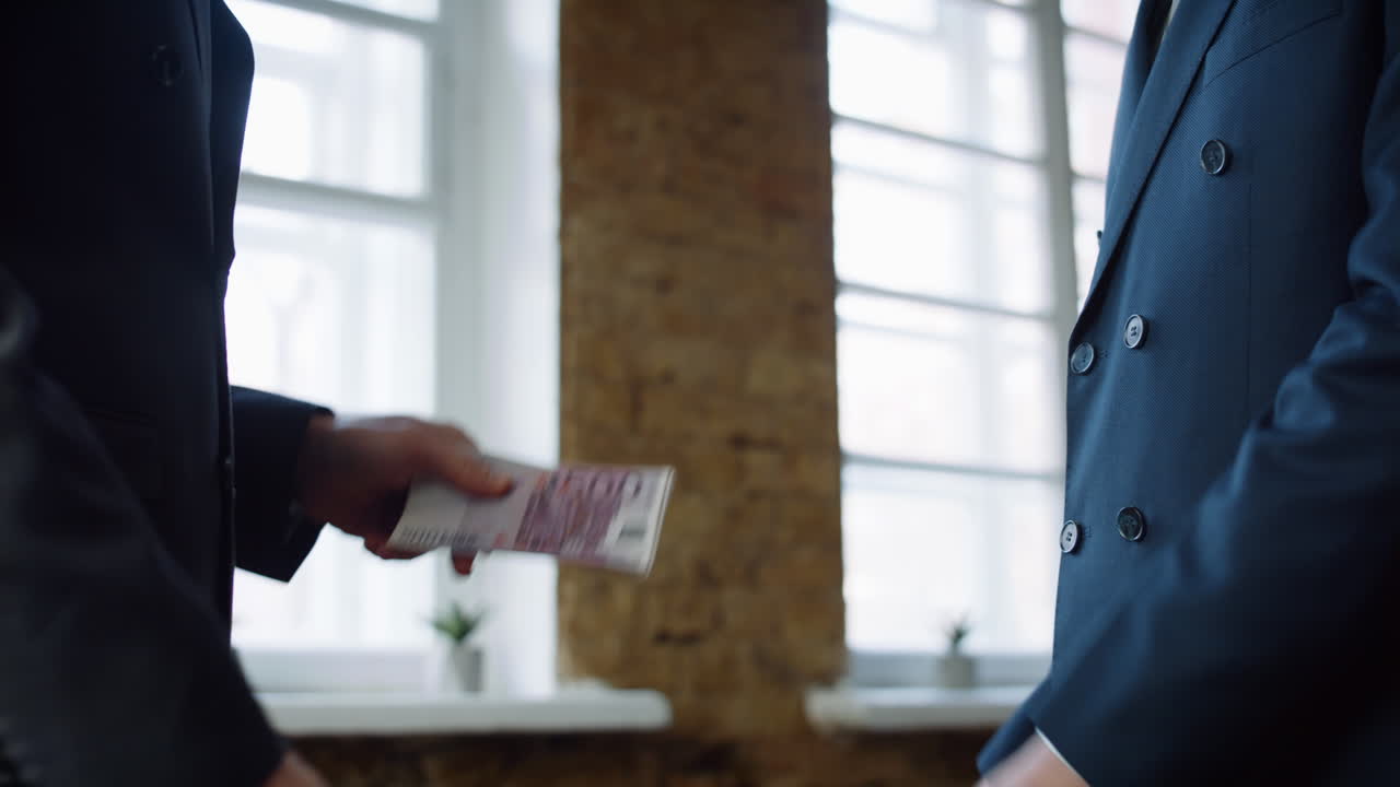 Boss hand giving money bonus for successful employee at office meeting close up.