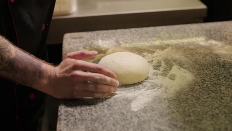 man cooking pizza in the kitchen of restaurant