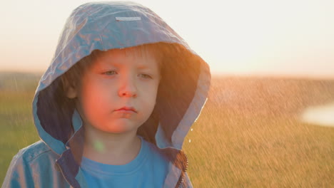 boy seeks warmth in storm against sunlight sad child stands firm as symbol of defiance against