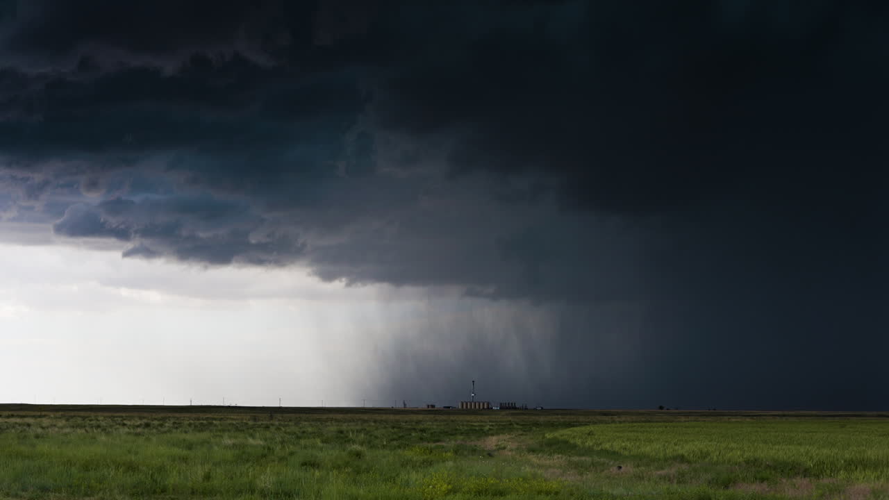 Shafts of rain falling beneath a dark storm cloud