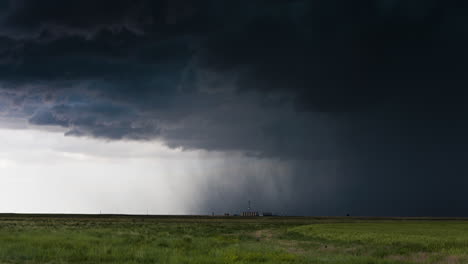 shafts of rain falling beneath a dark storm cloud